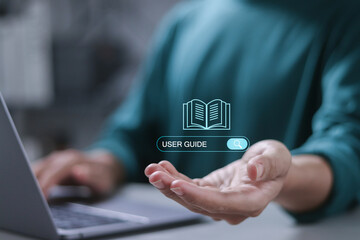 User manual guide, Online instruction manual and strategy advice. Businessman using laptop to...
