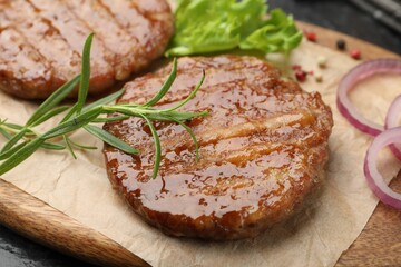 Delicious hamburger patties and spices on table, closeup