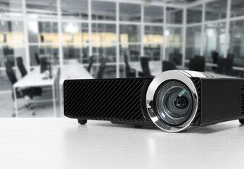 Modern video projector on white table in office