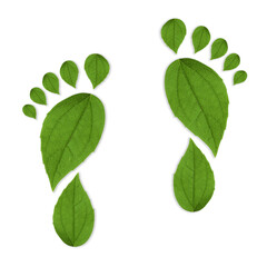 Human footprints made of green leaves on white background, top view. Environmental care, ecology protection, reducing CO2 emission