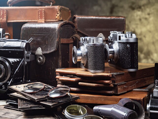 Collection of old cameras, on wooden background.