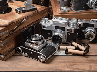 Collection of old cameras, on wooden background.