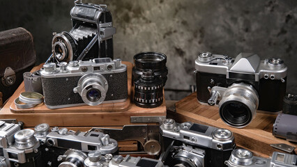 Collection of old cameras, on wooden background.