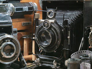 Old cameras in a composition on a wooden background