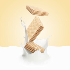 Tasty crispy wafers falling into splashing milk against beige beige background