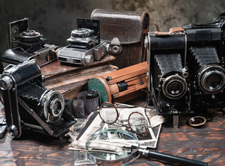 Collection of old cameras, on wooden background.