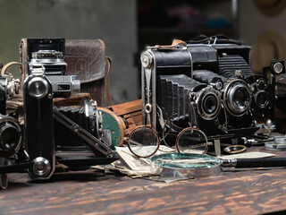 Collection of old cameras, on wooden background.