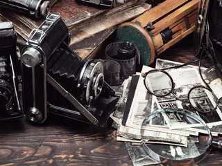 Collection of old cameras, on wooden background.