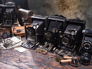 Collection of old cameras, on wooden background.
