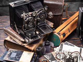 Collection of old cameras, on wooden background.