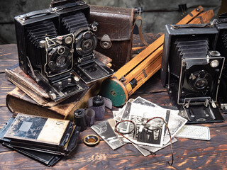 Collection of old cameras, on wooden background.