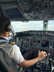 Airline pilot in commercial aircraft cockpit during flight