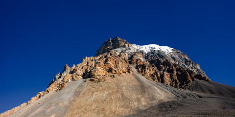 Panoramic view of the Yakwakang peak summit against blue sky. View  from the descent from Thorung La to Muktinath. Annapurna circuit trek, Himalaya mountains, Nepal.