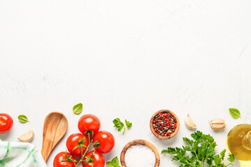 Spices, herbs and vegetables with olive oil on white kitchen table.