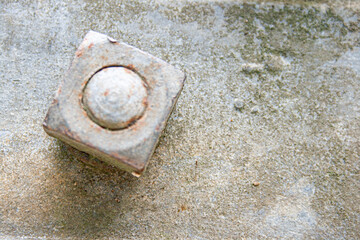 Spectacular texture of corroded metal with a nut due to being in a jungle environment.