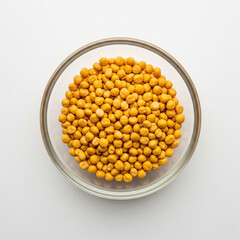 Chana dal naturally scattered in a borosilicate glass bowl, top-view close-up on white background