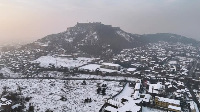 Aerial shots of Kashmir city draped in snow near the iconic Hari Parvat.