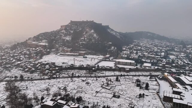 Aerial drone footage of snow cover kashmir city near Hari parvat in kashmir
