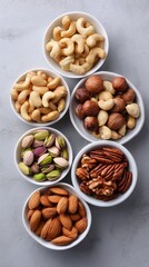 Variety of Nuts Displayed in Bowls on a Neutral Surface During Daytime