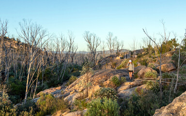 Woman Hiking at Booroomba Rocks Lookout, Namadgi National Park, ACT – Scenic Granite Cliffs and Mountain Trail Adventure at Sunset
