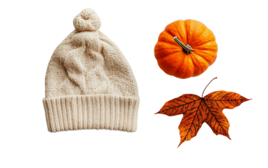 Warm fall knit hat featuring leaf pattern next to seasonal pumpkin decor Isolated on Transparent Background PNG