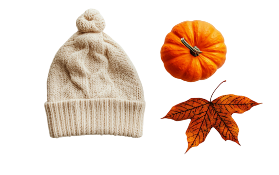 Warm fall knit hat featuring leaf pattern next to seasonal pumpkin decor Isolated on Transparent Background PNG