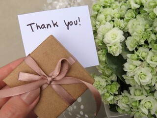 Woman hand holding a white card with the expression 