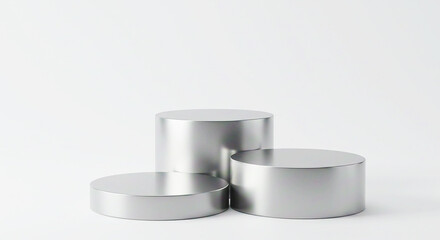 Three silver cylindrical podiums arranged in a staggered formation against a white background studio shot
