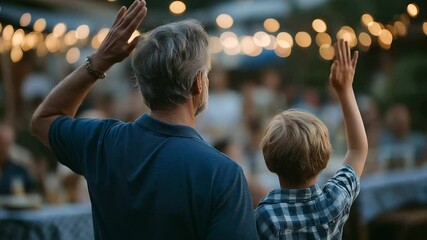 A father and son proudly salute the American flag at an Independence Day event. - Powered by Adobe