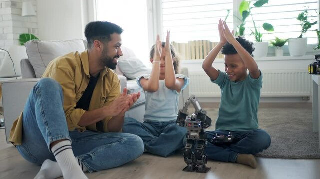 Father teaching kids about STEM, robotics, and discussing technology.