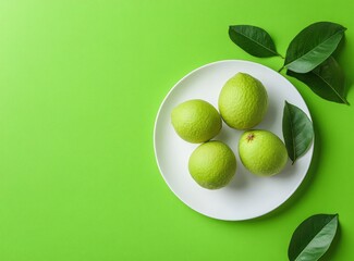 Green Fruit on White Plate with Leaves