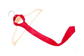 A slim fit red tie hanging on white background closeup view 