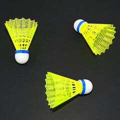 Shuttlecock rackets on black background close-up view group objects sports accessories concept 
