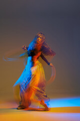 Modern jazz-funk dancer captured mid-motion with expressive blur and neon light trails,...