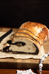 Homemade Poppy Seed Roll Sliced on Wooden Board for Dessert