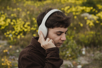 Man Relaxing On The Shore During Spring Time While Listening To Music 