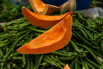Pumpkin and okra for sale at a street market. Healthy food. Rich in nutrients.