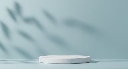 Minimalist white podium with leaf shadows on a blue background