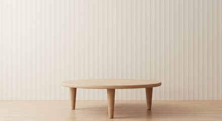 Minimalist round wooden table against a textured beige wall backdrop