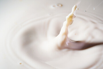 Close up shot of splashing fresh milk on container