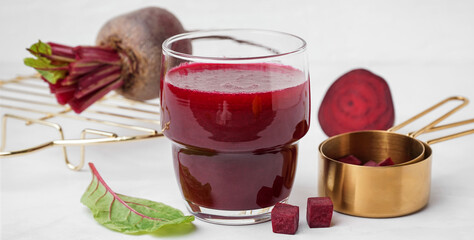 Glass of fresh beetroot juice on white background
