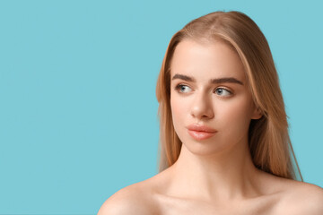 Young woman with beautiful lips on blue background