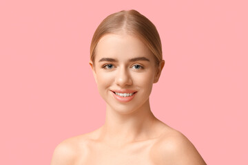 Smiling young woman with beautiful lips on pink background