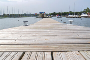 Fototapeta premium wooden bridge on the lake moored boats