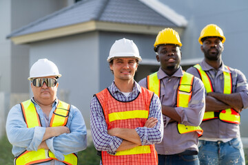Construction project engineers with architects or multi-national personnel working together on a construction site, selecting focus, teamwork concept.