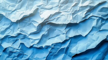Crumpled paper with light and dark shades creates a dynamic, textured surface