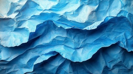 Abstract view of crumpled blue paper, textured and layered