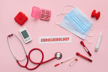 Word ENDOCRINOLOGY with medical supplies on pink background