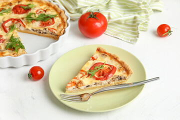 Plate with piece of delicious tomato tart on white background