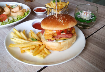 Burger and fries on white plate